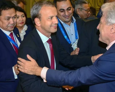 Delegates congratulate newly elected FIDE president Arkady Dvorkovich with handshakes at a formal gathering